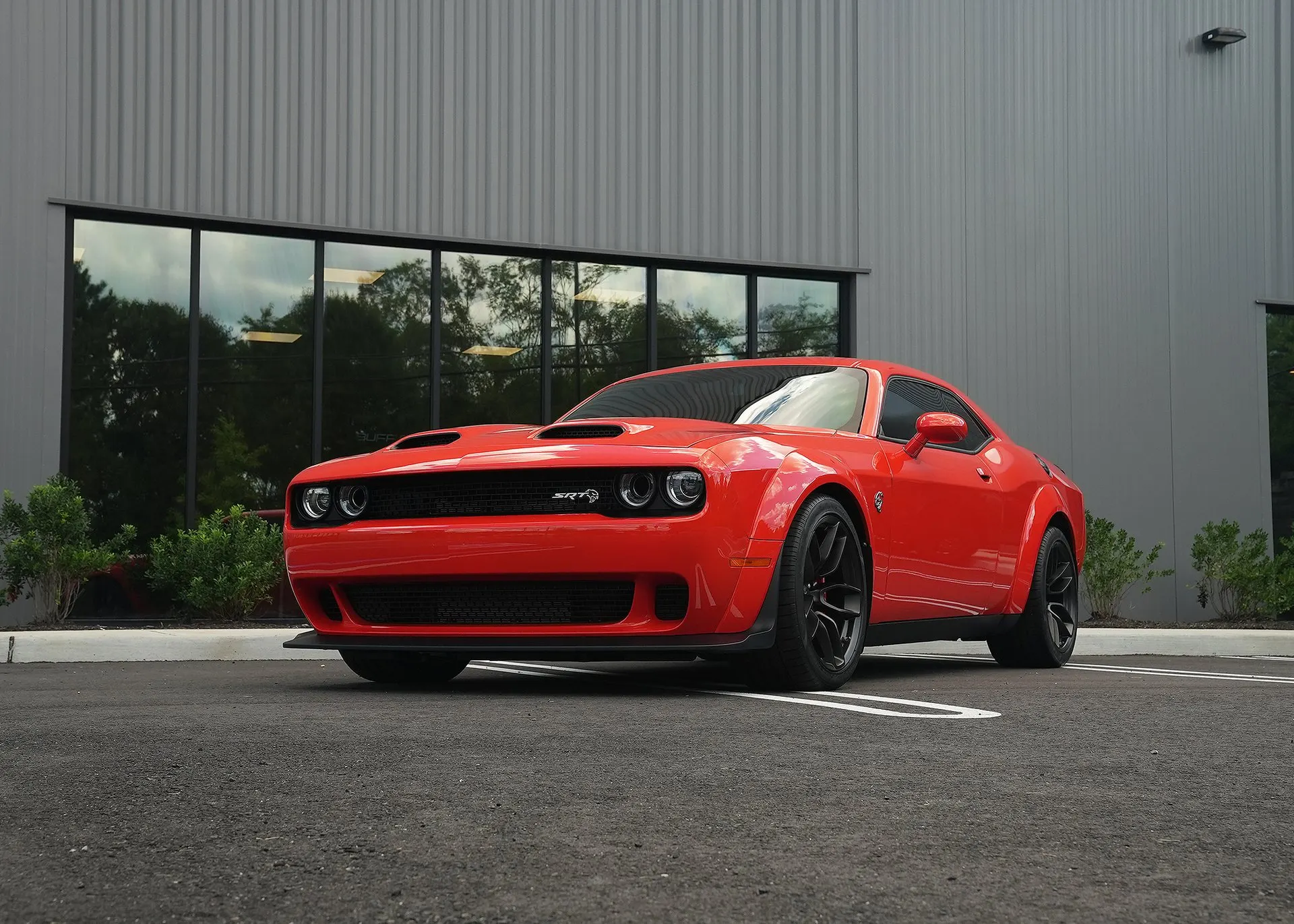 A red Challenger outside the shop