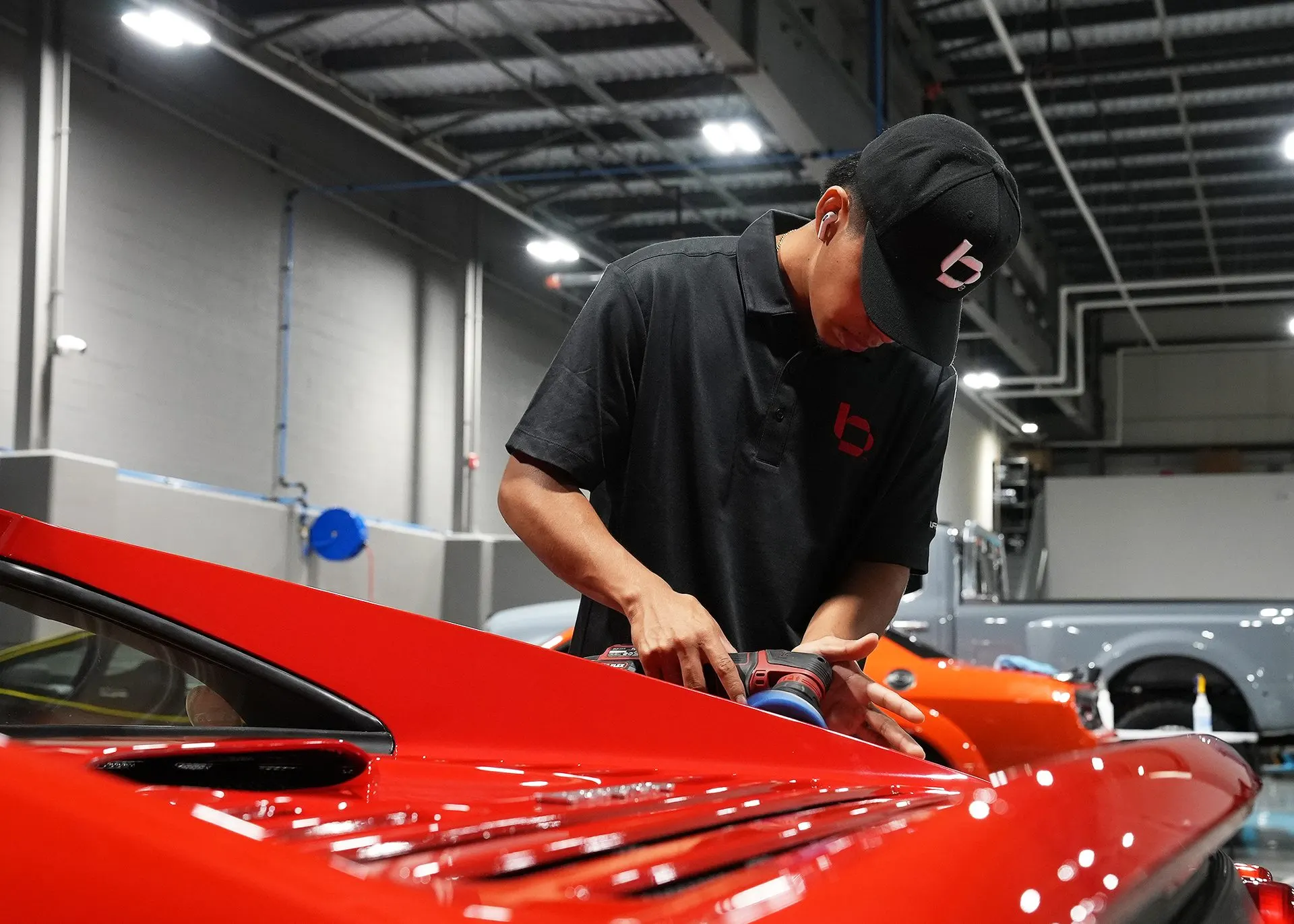 A Ferrari being polished in the bay