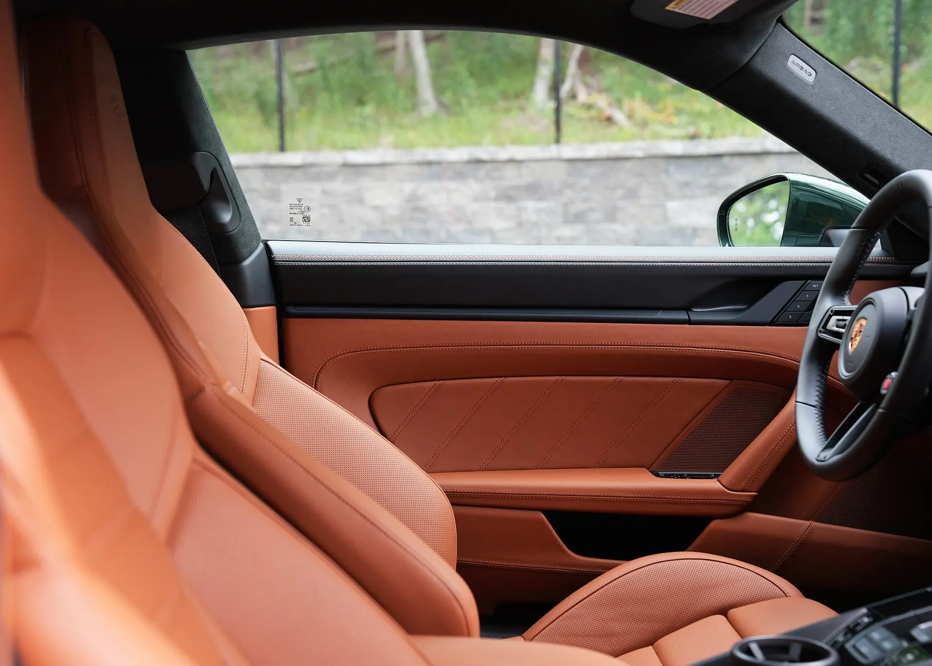 Looking out through the passenger window of a Porsche